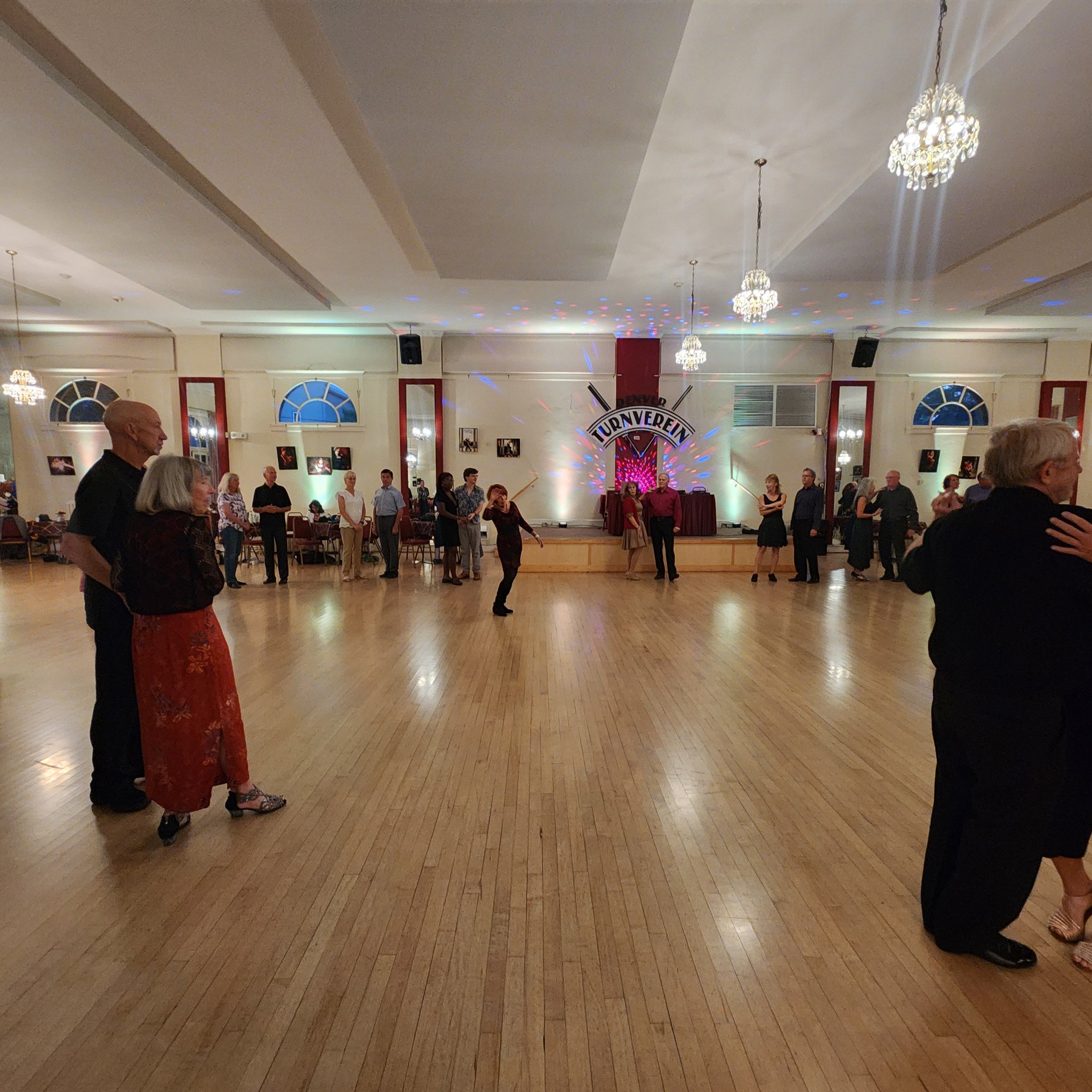 Crowd dancing under club lights at the Denver Turnverein